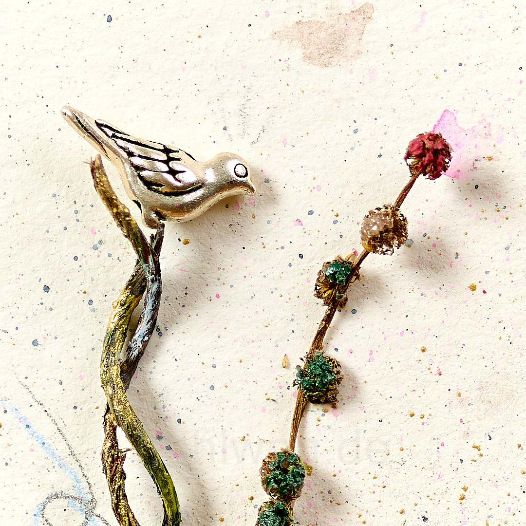 Collage mit Fundstücken und silbernem Vogel auf Aquarell