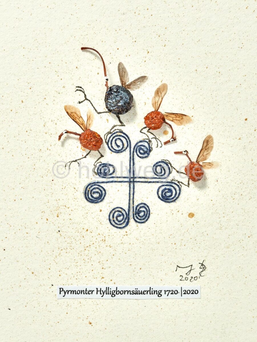Collage titled “Hylligenbornsäuerling,” featuring four winged fantasy figures made from dried fruits and plant materials arranged around a Pyrmont anchor cross.
