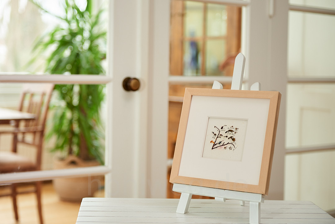 Miniature collage presented on a table easel in the room