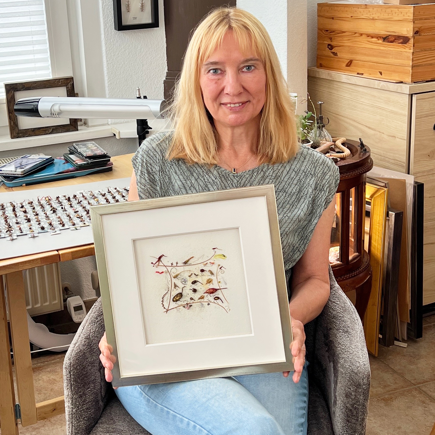 Magdalena Hohlweg is exhibiting her framed assemblage titled "The Navel of the World" in her studio.